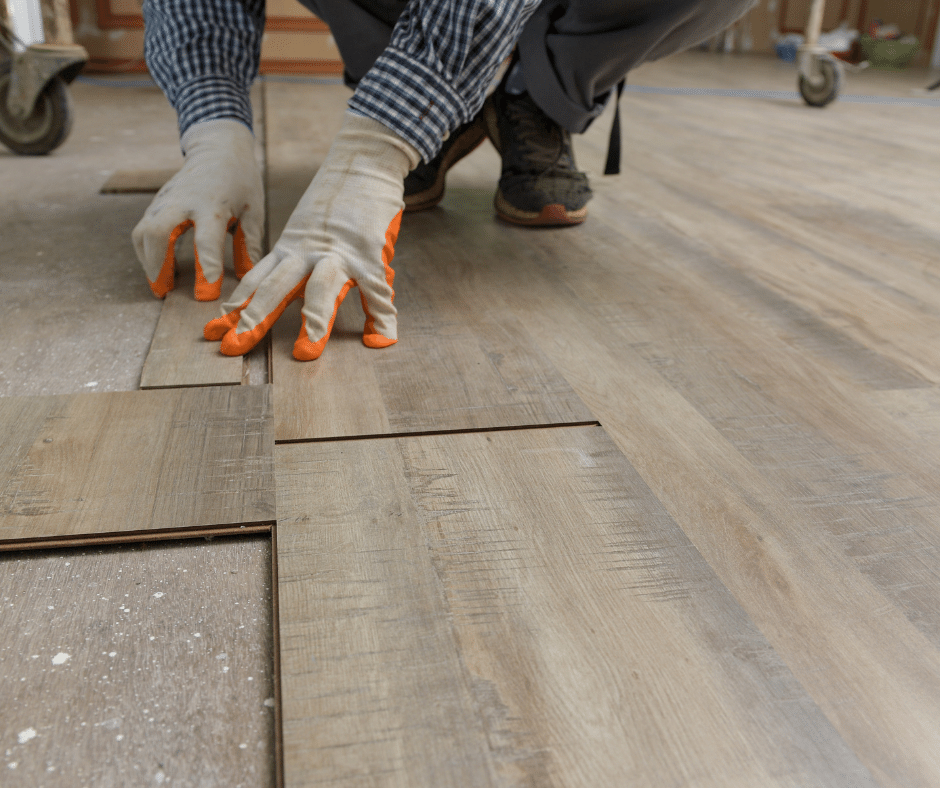 Image of vinyl plank floors being cut and installed