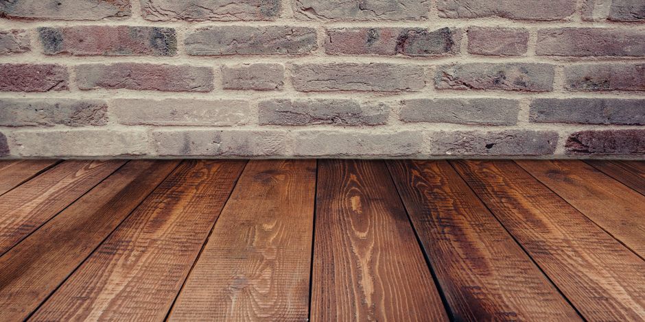 wood look flooring in a cosy Surrey living room with wet boots muddy paws and rain outside